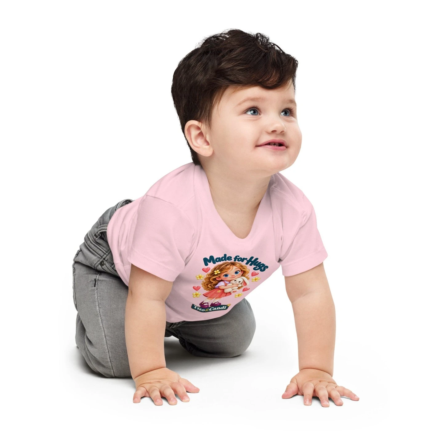 Baby in a pink T-shirt with Alice hugging her plush bunny, hearts, yellow flowers and the words Made for Hugs
