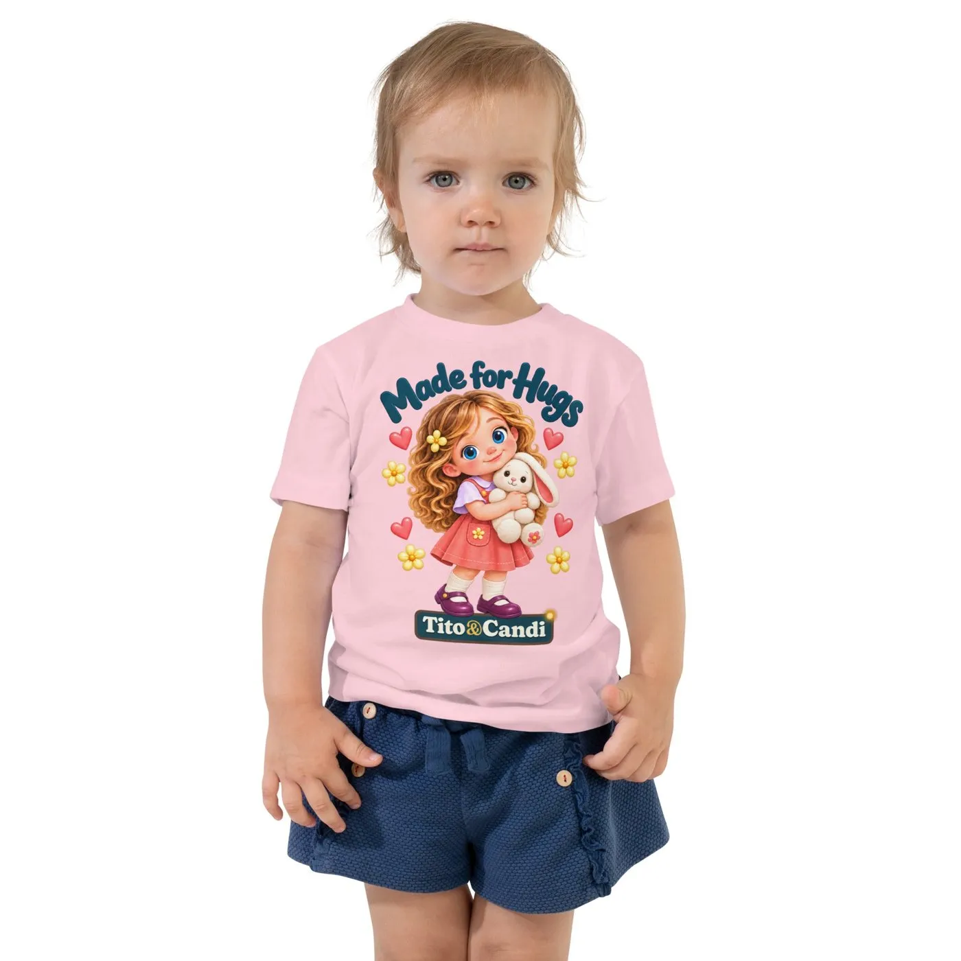 Toddler in a pink T-shirt with Alice hugging her plush bunny and the words Made for Hugs