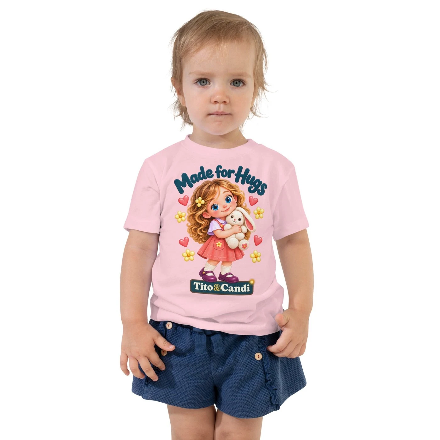 Toddler in a pink T-shirt with Alice hugging her plush bunny and the words Made for Hugs